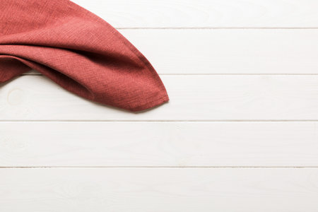 top view with red empty kitchen napkin isolated on table background. Folded cloth for mockup with copy space, Flat lay. minimal style.の写真素材