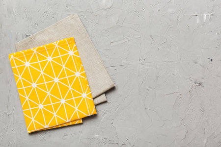 top view with yellow empty kitchen napkin isolated on table background. Folded cloth for mockup with copy space, Flat lay. minimal style.の写真素材