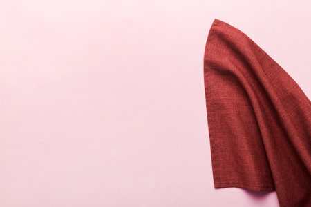 top view with red empty kitchen napkin isolated on table background. Folded cloth for mockup with copy space, Flat lay. minimal style.の写真素材