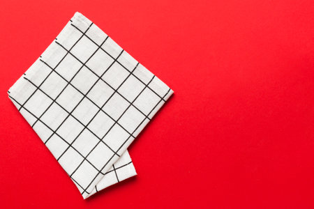 top view with white empty kitchen napkin isolated on table background. Folded cloth for mockup with copy space, Flat lay. minimal style.の写真素材