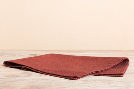 top view with red empty kitchen napkin isolated on table background. Folded cloth for mockup with copy space, Flat lay. minimal style.の写真素材