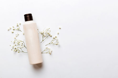Fancy healthcare bottles for cream with gypsophila branch. Natural oranic spa cosmetics concept. Mockup, template, top view.の写真素材
