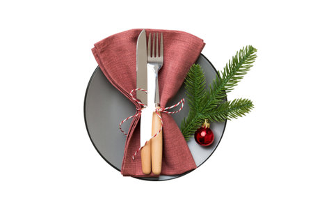 isolated christmas Plate with decor and fork and spoon. new year holiday background. top view.