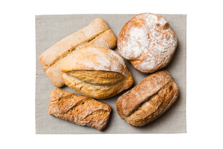 Freshly baked delicious french bread with napkin isolated on white background top view. Healthy...