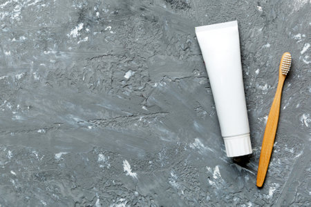 toothpaste and toothbrush top view with copy space on colored background. flat lay. dental hygiene. Oral care products on light background. body care concept.の写真素材