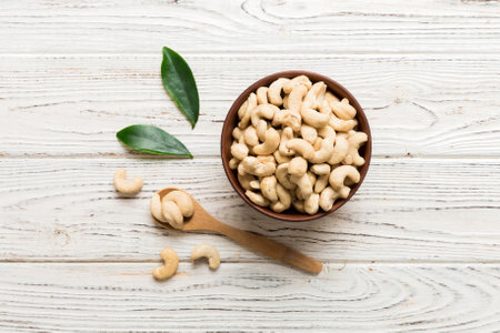 cashew nuts in wooden bowl on table background. top view. Space for text. healthy foodの写真素材
