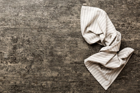 top view with gray kitchen napkin isolated on table background. Folded cloth for mockup with copy space, Flat lay. minimal style.の写真素材
