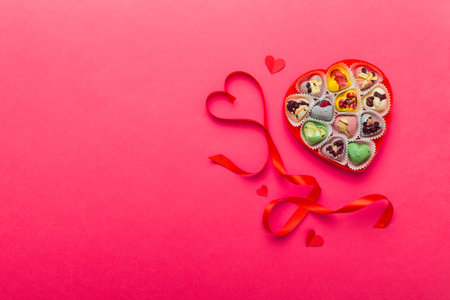 Valentine day composition: sweet candy, with gift boxes with bow and red felt hearts, photo template, background. Top view with copy space.の写真素材