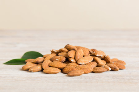 Close-up of Almond nuts with leaves on table background. top view. flat lay.の写真素材