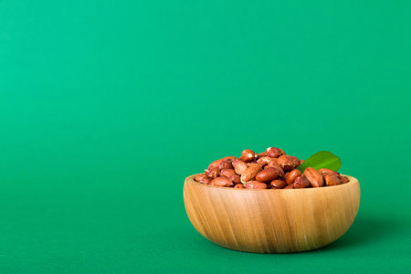 Fresh healthy peanuts in bowl on colored table background. Top view Healthy eating bertholletia concept. super foods.の写真素材