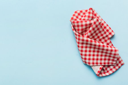 top view with red empty kitchen napkin isolated on table background. Folded cloth for mockup with copy space, Flat lay. minimal style.の写真素材