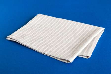 top view with gray kitchen napkin isolated on table background. Folded cloth for mockup with copy space, Flat lay. minimal style.の写真素材