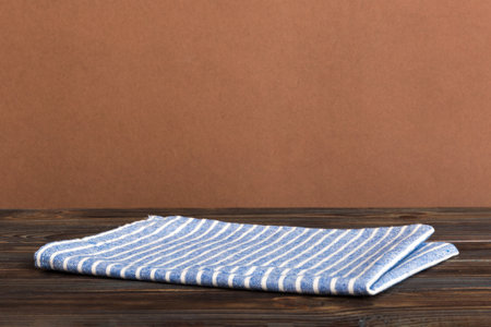 top view with blue kitchen napkin isolated on table background. Folded cloth for mockup with copy space, Flat lay. minimal style.の写真素材
