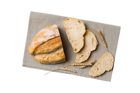 Freshly baked bread slices on napkin against isolated on white background. top view Sliced bread.