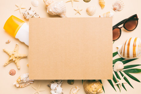 Summer time concept with blank greeting card and blank craft paper on colored background. Seashells from ocean shore in the shape of frame separated with space for text top view.の写真素材