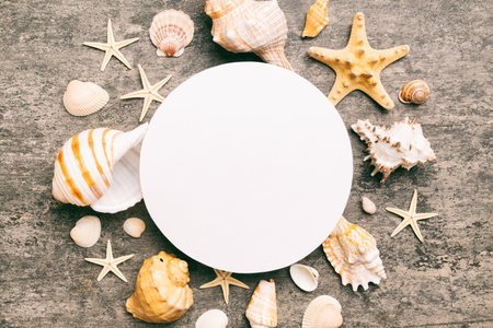 Summer time concept with blank greeting card and blank white paper on colored background. Seashells...