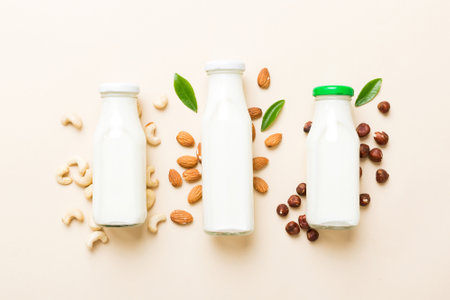 Set or collection of various vegan milk almond, cashew, on table background. Vegan plant based milk...
