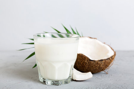 coconut products on white wooden table background. Dairy free milk substitute drink, Flat lay healthy eating.の写真素材