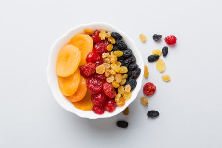 Bowl with different dried fruits on table background, top view. Healthy lifestyle with copy space.の写真素材
