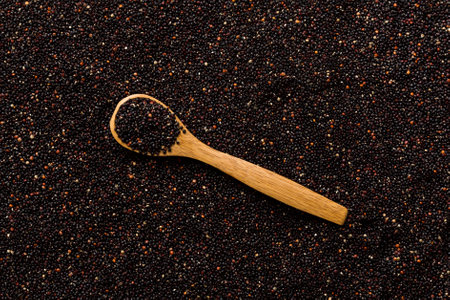 black quinoa grain in wooden spoon background and texture of gluten free top view.の写真素材