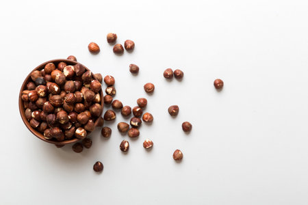 Wooden bowl full of hazelnuts on table background. Healthy eating concept. super foods.
