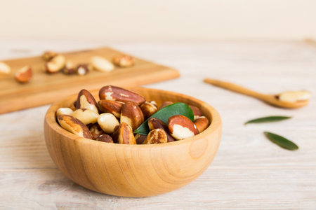 Fresh healthy Brazil nuts in bowl on colored table background. Top view Healthy eating bertholletia concept. super foods.の写真素材