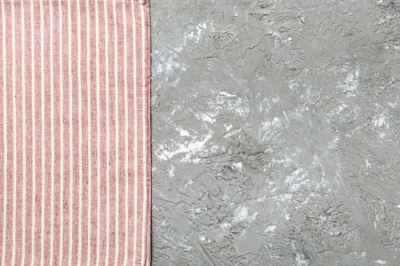 top view with red empty kitchen napkin isolated on table background. Folded cloth for mockup with...