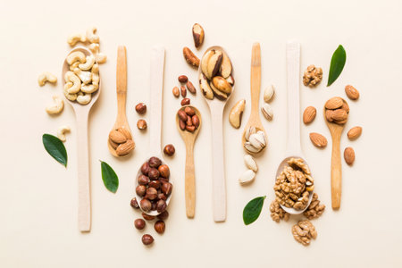 mixed nuts in white wooden spoon. Mix of various nuts on colored background. pistachios, cashews, walnuts, hazelnuts, peanuts and brazil nuts.の写真素材