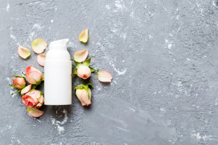 Fancy healthcare bottles for cream with rose flower. Natural oranic spa cosmetics concept. Mockup, template, top view.の写真素材