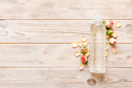 Fancy healthcare bottles for serum, micellar, tonic, toner, lotion, water and cream with rose flower. Natural oranic spa cosmetics concept. Mockup, template, top view.の写真素材