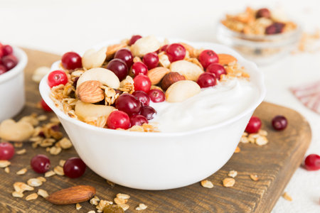 Healthy breakfast food with granola, yogurt, fruits and nuts. Dessert parfait with dried fruits for breakfast.の写真素材