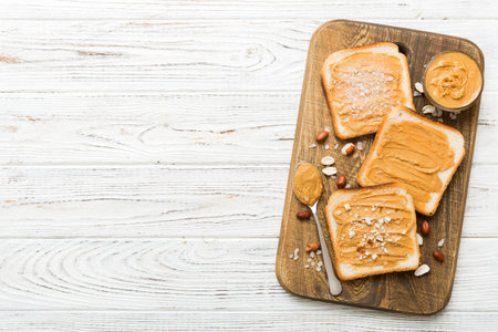 Peanut butter sandwiches or toasts on light table background.Breakfast. Vegetarian food. American cuisine top view with copy space.の写真素材