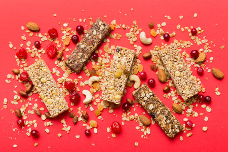 Various granola bars on table background. Cereal granola bars. Superfood breakfast bars with oats, nuts and berries, close up. superfood concept.の写真素材