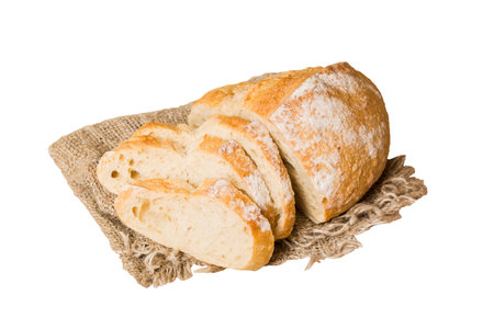 Assortment of freshly sliced baked bread with napkin isolated on white background. Healthy...