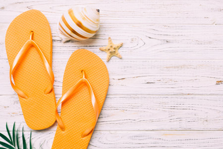 Flat lay composition with flip flops and seashell on colored background. Space for text view.の写真素材