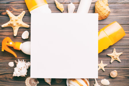 Summer time concept with blank greeting card and blank white paper on colored background. Seashells from ocean shore in the shape of frame separated with space for text top view.の写真素材