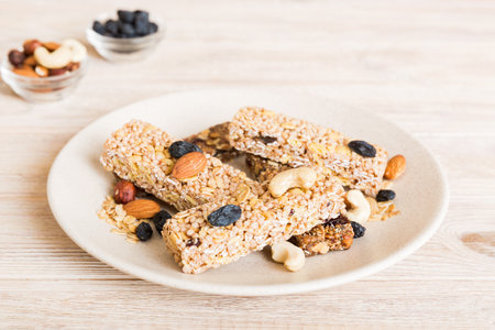 Various granola bars on table background. Cereal granola bars. Superfood breakfast bars with oats,...