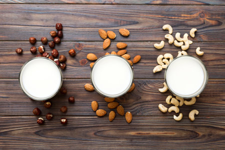 Set or collection of various vegan milk almond, cashew, on table background. Vegan plant based milk...