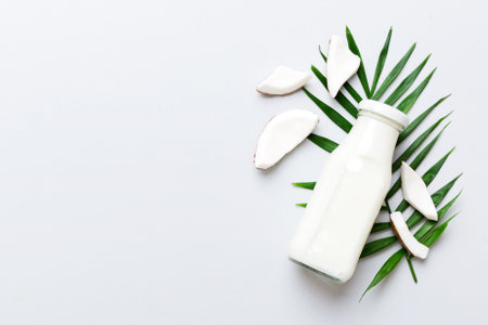 coconut products on white wooden table background. Dairy free milk substitute drink, Flat lay healthy eating.の写真素材