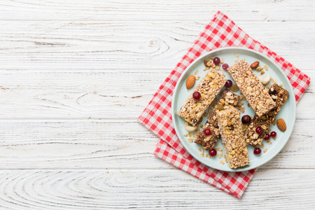 Various granola bars on table background. Cereal granola bars. Superfood breakfast bars with oats, nuts and berries, close up. superfood concept.の写真素材