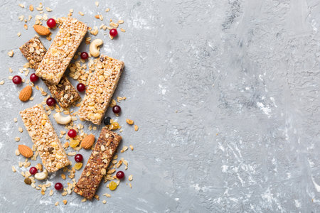Various granola bars on table background. Cereal granola bars. Superfood breakfast bars with oats, nuts and berries, close up. superfood concept.の写真素材