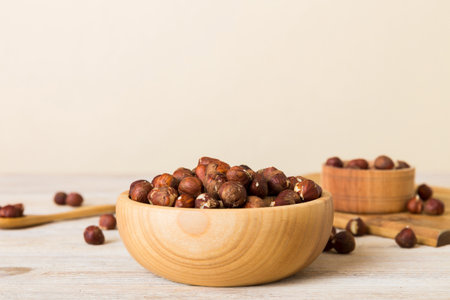 Wooden bowl full of hazelnuts on table background. Healthy eating concept. super foods.
