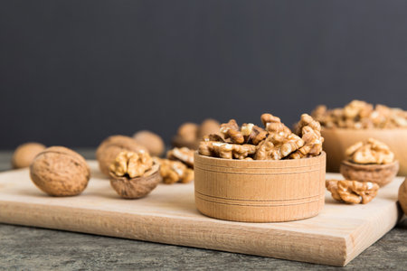 Fresh healthy walnuts in bowl on colored table background. Top view Healthy eating bertholletia...