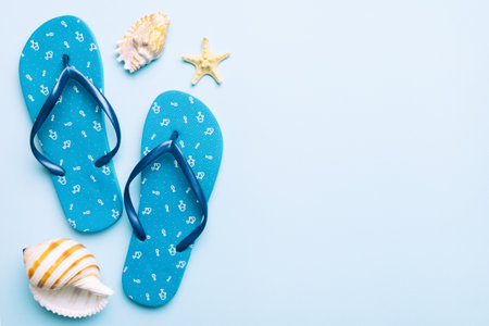 Flat lay composition with flip flops and seashell on colored background. Space for text view.の写真素材