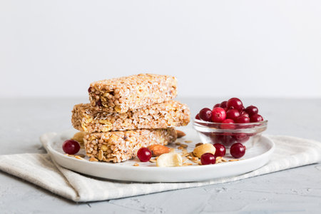 Various granola bars on table background. Cereal granola bars. Superfood breakfast bars with oats, nuts and berries, close up. superfood concept.の写真素材