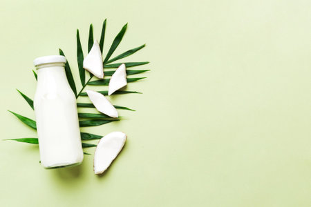 coconut products on white wooden table background. Dairy free milk substitute drink, Flat lay healthy eating.の写真素材