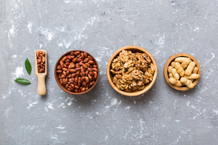 Walnut kernel halves, in a wooden bowl. Close-up, from above on colored background. Healthy eating Walnut concept. Super foods with copy space.の写真素材