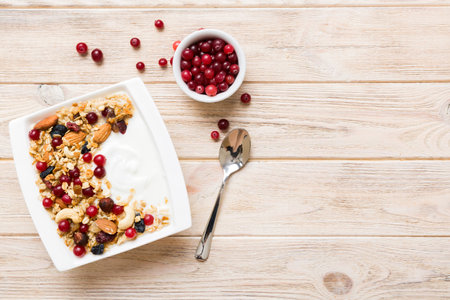 Healthy breakfast food with granola, yogurt, fruits and nuts. Dessert parfait with dried fruits for breakfast.の写真素材