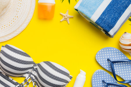 Woman swimwear and beach accessories flat lay top view on colored background Summer travel concept....