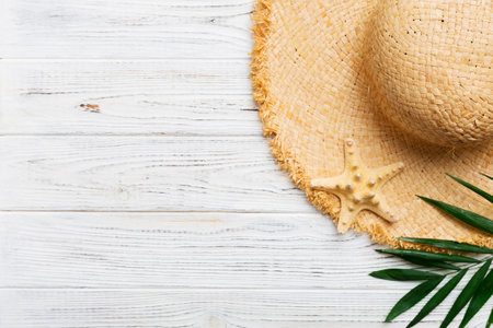 Summer holidays. Summer concept with straw hat and tropical leaf. Flat lay, top view, copy space.の写真素材